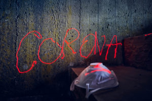 Symbolic picture, menekel on concrete wall, Corona lettering, handwriting with red laser beam, respirator Symbolic picture, menekel on concrete wall, Corona lettering, handwriting with red laser beam, respirator